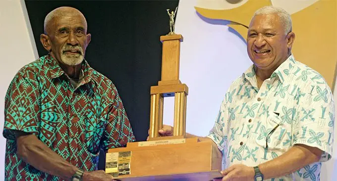 Jolame Turaganigali (left) receiving the Fiji Sports Council 2018 Fiji Sports Award Sportsman of the Year award on behalf of his son, Alivereti Veitokani from Prime Minister Voreqe Bainimarama at FMF Gymnasium on March 01, 2019. Photos: Ronald Kumar.
