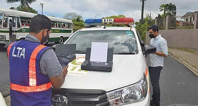 Land Transport Authority officers mends a checkpoint.