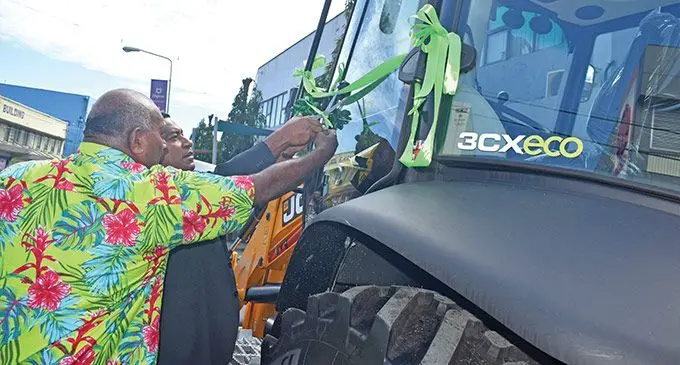 Minister for Housing and Local Government, Maciu Katamotu Nalumisa (left), with the Tui Nawaka Ratu Tomasi Kanailagi Naevo cutting the ribbon for the new backhoe loader at Nadi Town. Photo: Mereleki Nai