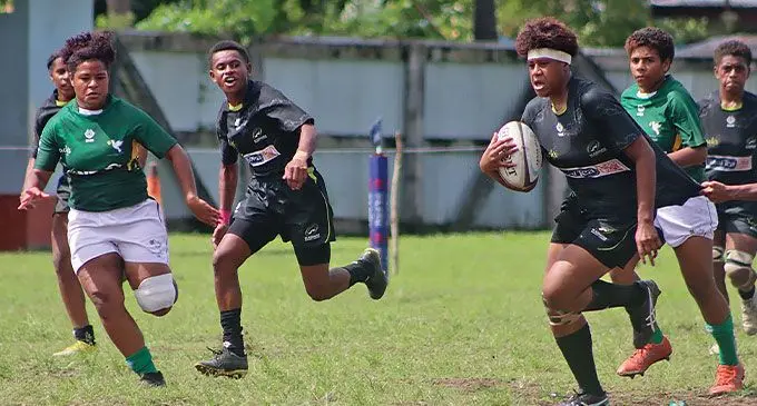 A Kadavu player bursts through the Tailevu defense at Lawaqa Park, Sigatoka.