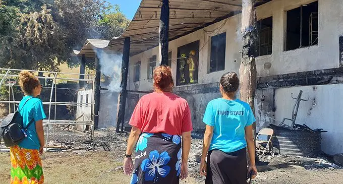 The Simpson family watch on as firefighters work to put out the flames at the family’s home in Tuvu, Lautoka after it was destroyed in a fire on August 9, 2020.   Photo: Nicolette Chambers