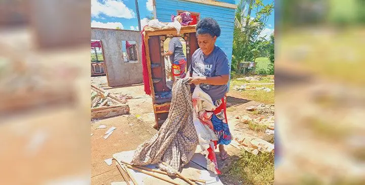 Nina Taiviu, 46, folding and drying some of the remaining clothes following the whirlwind at Sarava, Labasa on March 19, 2025. Photo: Sampras Anand.