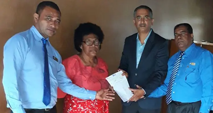 Makareta Koroi (second from left), the mother of the late Siuta Niumataiwalu receives Claim cheque from Life Insurance Corporation of India General Manager YS Ashok (right).