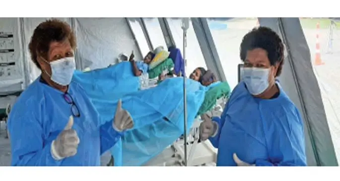 (Right) Mid wives Karalaini Macanawai and Meresimani Kauata tend to Doctor Michelle Manisha (closest bed to camera) and Shayal Pritika Devi at the Field Hospital in Lautoka.