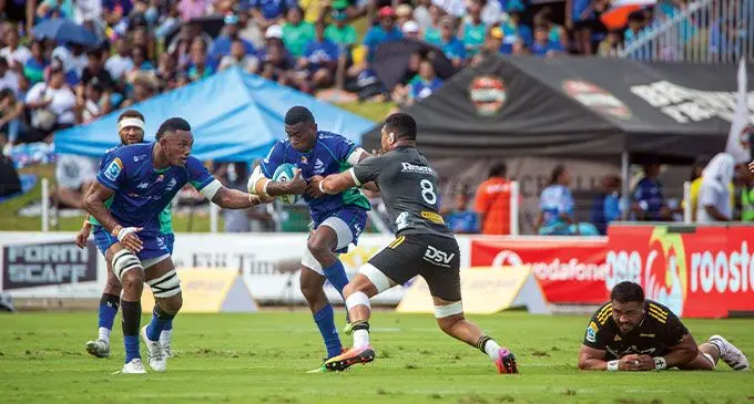 Swire Shipping Fijian Drua winger Taniela Rakuro (with ball) fends off Hurricanes captain Ardie Savea while Vilive Miramira (left) offers his support during their Shop N Save Super Rugby Pacific Round 11 match at the HFC Bank Stadium on May 6, 2023. The Drua defeated Hurricanes 27-24. Photo: Leon Lord
