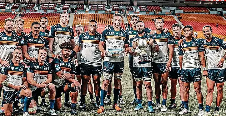 Safeguard Global ACT Brumbies players with the Rod Macqueen Cup after their Shop N Save Super Rugby Pacific win over Queensland Reds at the Suncorp Stadium in Brisbane, Australia, on April 8, 2023. Photo: ACT Brumbies