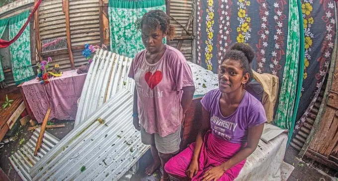 CLOSE CALL... Mere Meleyaga (left) and Arieta Cama escaped unhurt after their corrugated roofing iron missed hitting them as they lay asleep on the floor. Their home at Waidradra Village, Navua, was not spared after Tropical Cyclone Ana ravaged through the area. Ms Cama is five months pregnant. Photo: Leon Lord