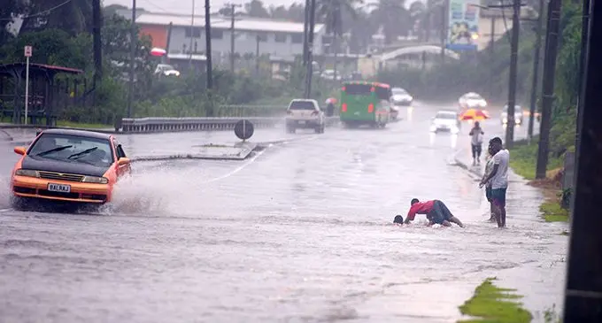The Prime Minister Voreqe Bainimarama has issued a stern warning to parents and guardians to monitor the whereabouts of their children as the whole of Fiji experience continuous rain and flooding. Pictured yesteday, children are seen here “rain bathing” along the Kings Road in Nasole, Nasinu, posing a risk to their lives and motorists.  Photo: Ronald Kumar