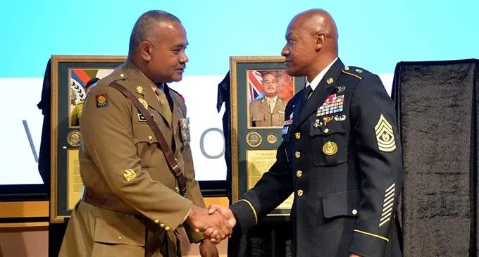 Land Force Sergeant Major Warrant Officer Class One (WO1) Joeli Rabuli, left, is congratulated after being inducted into International Student Hall of Fame.  Photo: RFMF Media Cell