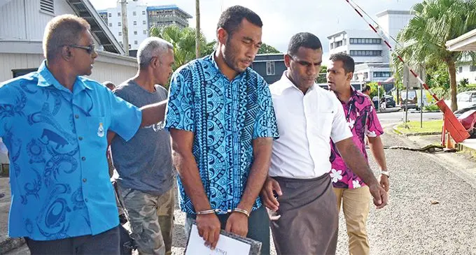Rusiate Raiwalui (middle) escorted by Police officers outside court on May 14, 2019. Photo: Ronald Kumar
