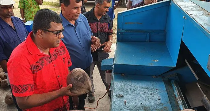 Minister for Agriculture, Waterways, Environment, Rural and Maritime Development, Mahendra Reddy commissions the new hot air, drier and de-husking machine. Photo: Supplied