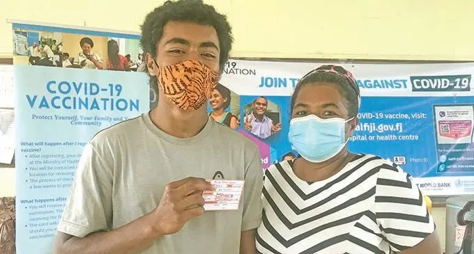 Marika  Kaitani was accompanied by his mother, Mereoni Tinaibui to get vaccinated at All Saints Secondary School on September 22,2021. Photo: Laisa Lui             
