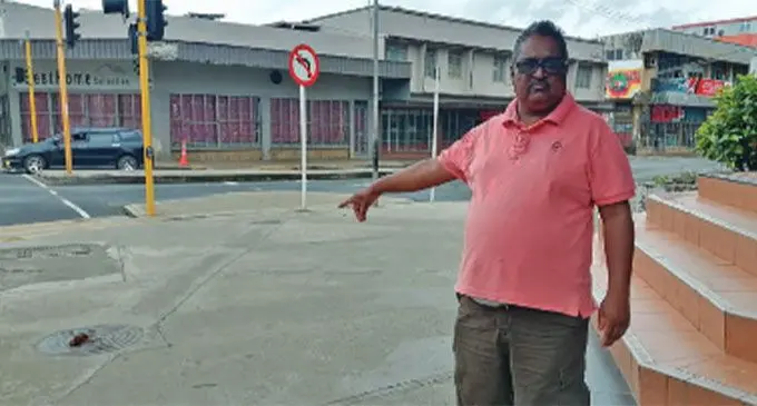 Bobby Janendra Vikash, the owner of Mega Paper Supplies, pointing to the human feces infront of his shop. Photos: Mereleki Nai