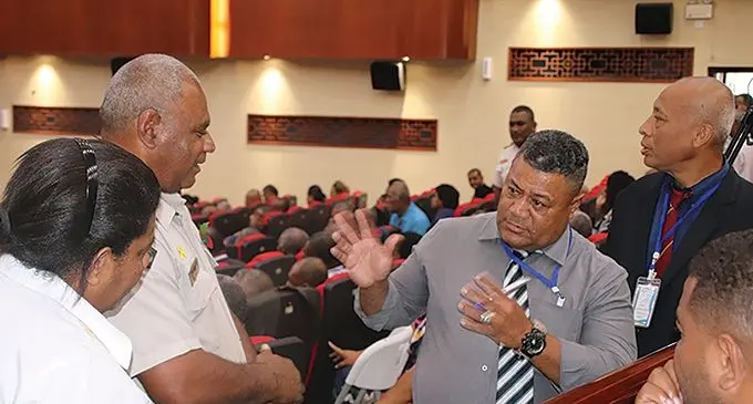 Chief Corrections officer Solomone Turaga in deep discussion with a church member.