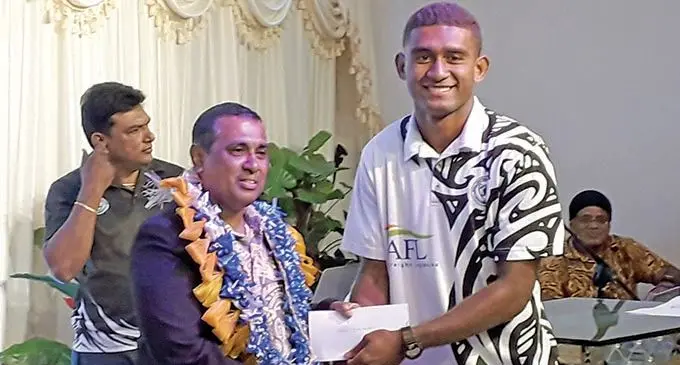 Assistant Minister for Ministry of Education, Heritage and Arts, Joseph Nitya Nand (left), makes a presentation to Semi Matalau, during the Suva Football Association awards night on December 21, 2020. Photo: Sereana Salalo