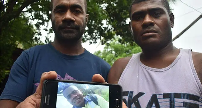From left: Kolinio Koroi and Gabriele Raiole at their home in Qina Settlement, Nawaka, Nadi are showing a picture of missing victim Peni Waqabaca on February 3, 2018.   Photo: Waisea Nasokia