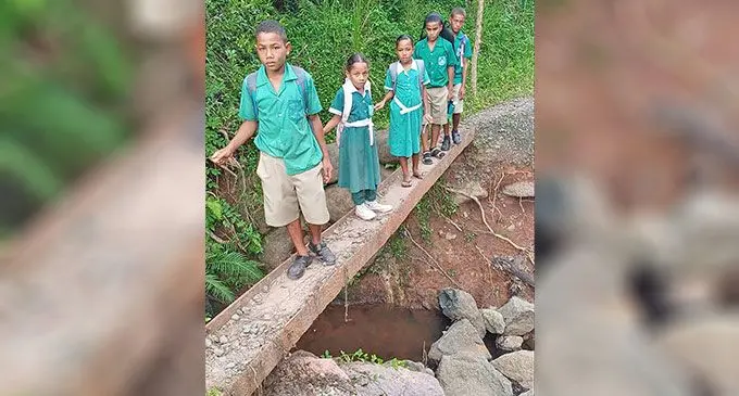 From Left: Iliesa Vosavakadua, Marica Kulia, Suliana Talei, Jack Bolatoga and Joji Ravala on the rusted steel beam used as a crossing to reach Lomaloma Settlement in Labasa on February 12, 2025. Photo: Shratika Naidu