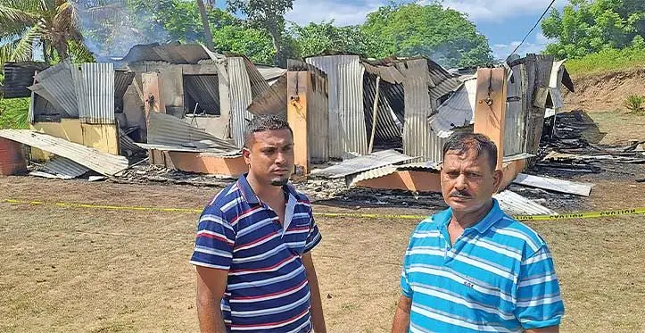 Sonal Kumar with his father Jai Kumar, in front of their damaged home. Photo: Waisea Nasokia