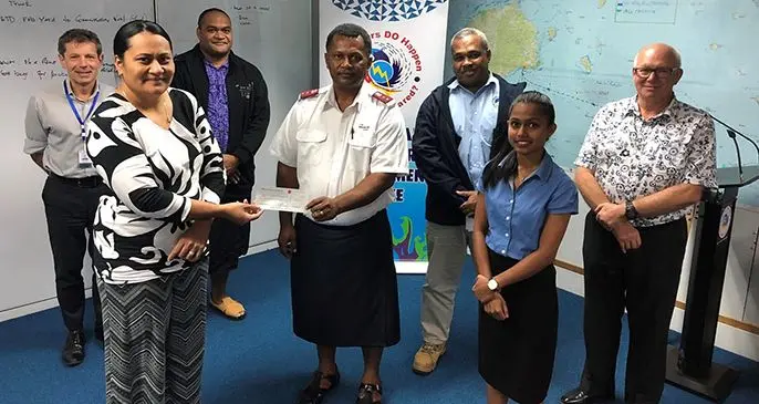National Disaster Management Office Director, Vasiti Soko receives donation from the Salvation Army.