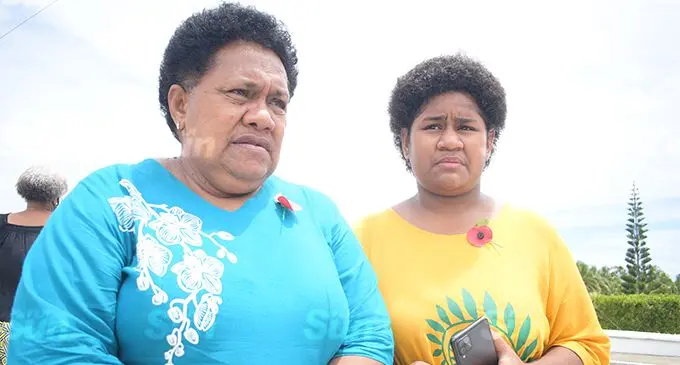 Lavenia Volaukitoga, 60, with her granddaughter, Wakesa Volaukitoga, 16, remember her late husband Private Seruvatu Volaukitoga during the Remembrance Day ceremony at the National War Memorial site in Veiuto on November 11, 2021.   Photo: Ronald Kumar