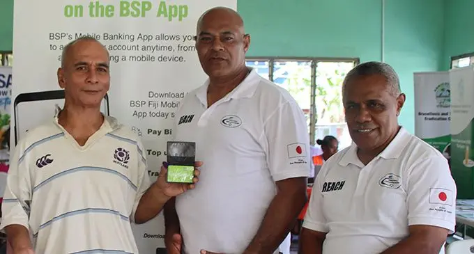 From left: Hare Soko with BSP reps Meli Tamani and Isikeli Taoi after opening his bank account in Oinafa, Rotuma. Photo: Josefa Babitu