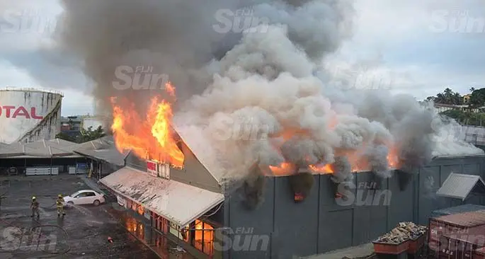 Fire raging fiercely from the Value City complex as thick clouds of smoke tower above the capital city yesterday afternoon. Photo: Ronald Kumar
