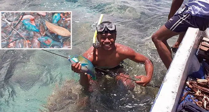 A youth who was part of the team that caught fish for the Sunday school picnic at Natokalau Village, Yawe, Kadavu. INSET: Bundles of fish ready to be cooked in an open fire for the Sunday school picnic.