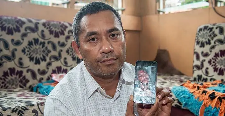 Sakiusa Bureisarasau showing a photo of his nephew, Navitalai Loatuicama at their home in Jittu on July 30, 2023. Photo: Leon Lord
