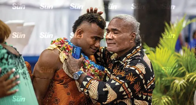 Seremaia Tuwai is congratulated by his father Poasa Vunisa inside the FMF Gymnassium on December 3, 2021. Photo: Leon Lord