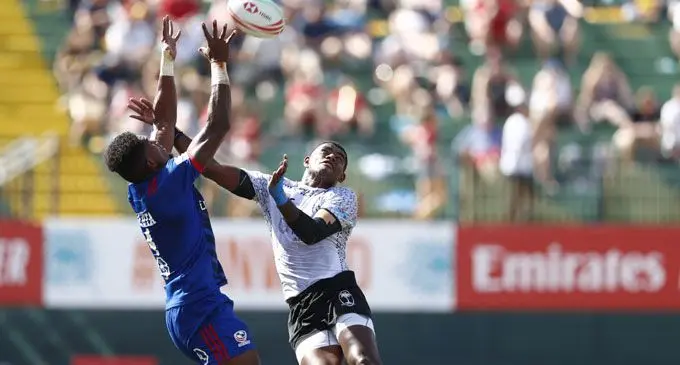 USA’s Matai Leuta and Fiji’s Aminiasi Tuimaba compete for a ball in the air in their Cup quarterfinal on day two of the Emirates Airline Dubai Rugby Sevens 2018 on December 1, 2018. Photo: World Rugby