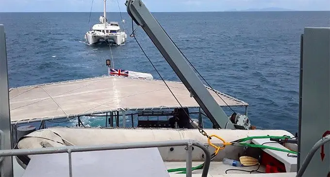 The troubled catamaran is towed to safety. Photo: FMSRCC