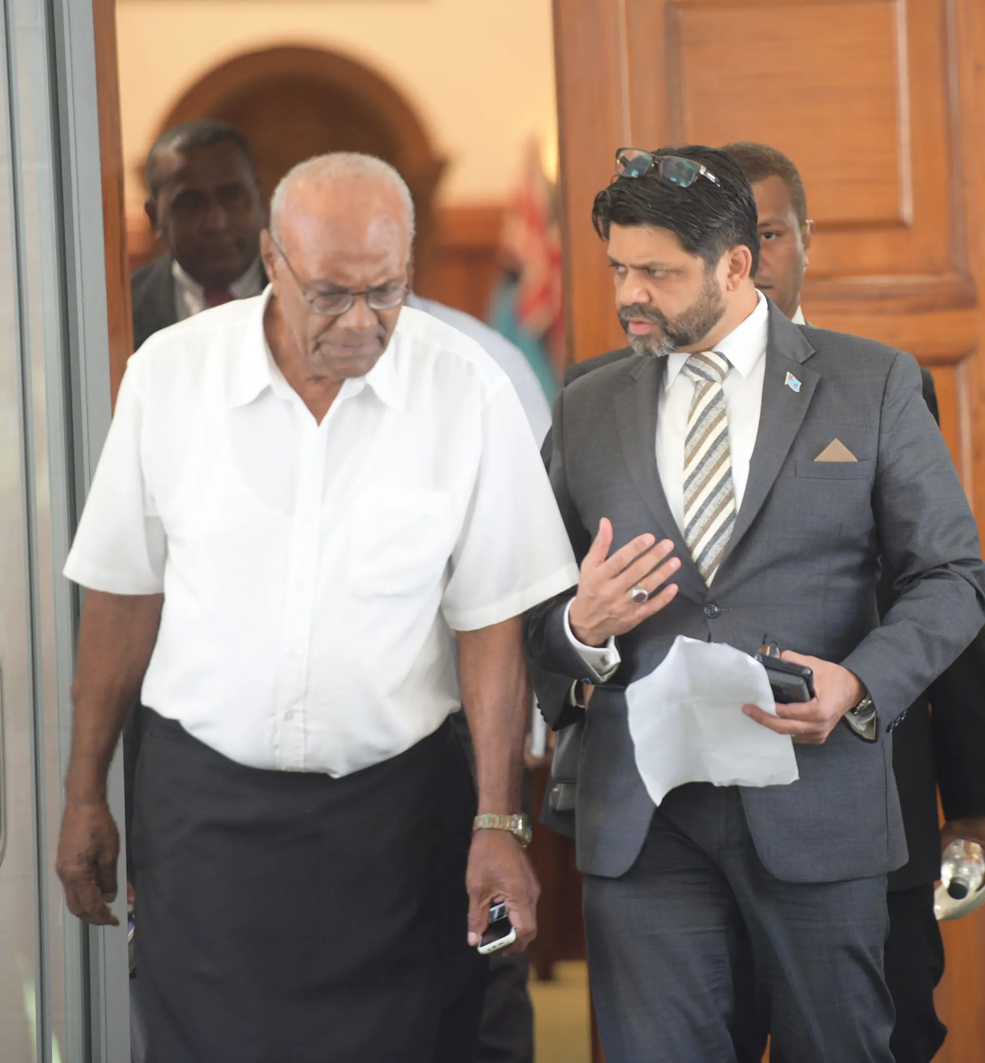 Attorney General and Minister for Economy Aiyaz Sayed-Khaiyum assist Penisoni Saukelea outside Parliament on April 2, 2019. Photo: Ronald Kumar.