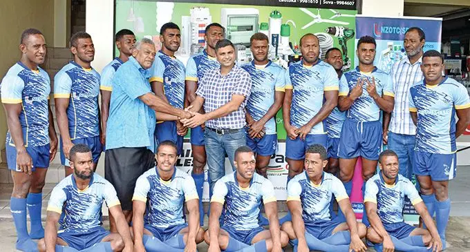 Wadigi Salvo manager Apimeleki Nasalo (standing, third from left) shakes hand with NZOTC (SP) PTE Limited general manager Bhawin Mishra while the players put on their new jersey in Lautoka on January 28, 2021. Photo: Salote Qalubau