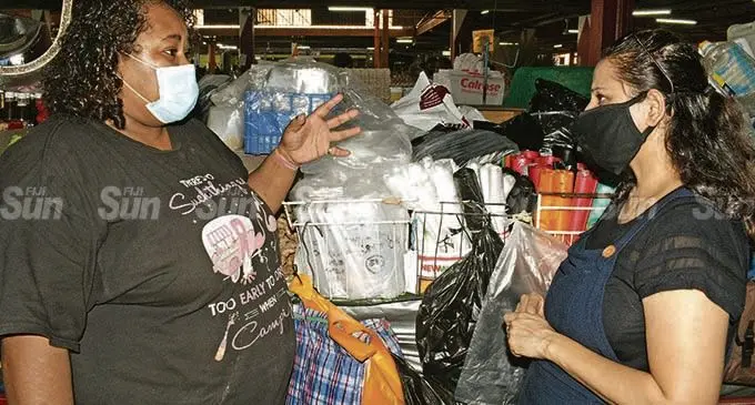 Market vendor Milika Ledua (left) is questioned by Ministry of Environment, Director Environment Sandeep Singh on the use of plastic by market vendors at Suva market during a recent check.  Photo: Ronald Kumar