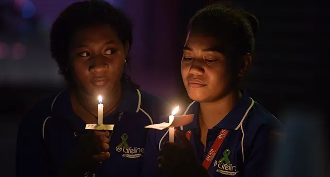 A light of hope…Lifeline Fiji volunteer Anaette Kula (left) and Freda Johnson during the Lifeline Fiji vigil to mark World Suicide Prevention Day at Terry Walk in Suva on September 10, 2019.  Photo: Ronald Kumar