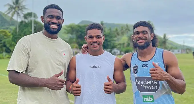 Swire Shipping Fijian Drua players who hail from Kadavu, from left: Vuate Karawalevu, Philip Baselala and Simione Kuruvoli at Namalata Central School, Kadavu on December 18, 2024. Photo: Fijian Drua