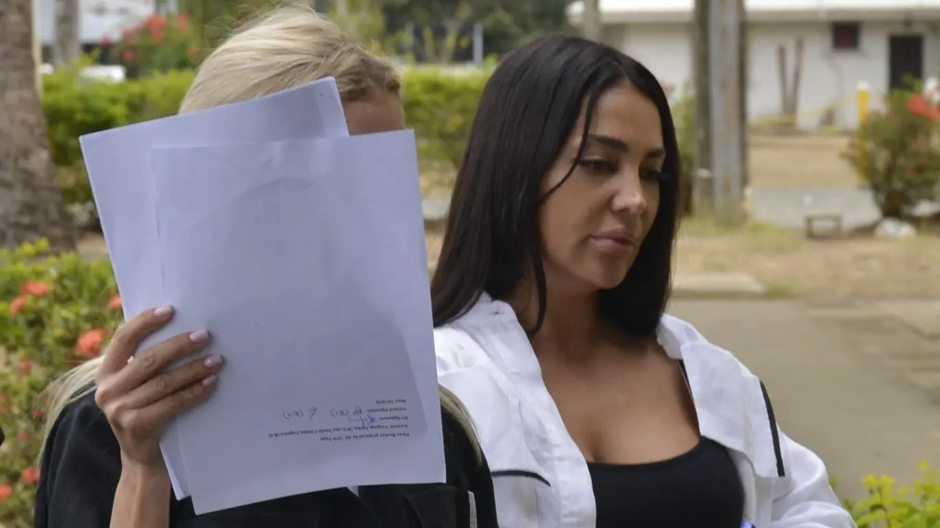 Ionela Christiana Lupasea, 32, and Virginia Verlan, 39, escorted by the police outside Nadi Magistrate Court on October 12, 2026.