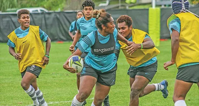Rooster Chicken Fijiana XVs hooker Bitila Tawake (with ball) looks for support while centre Sesenieli Donu and prop Mereoni Vonosere close in during training in Auckland, New Zealand on October 13, 2022. Photo: FRU Media