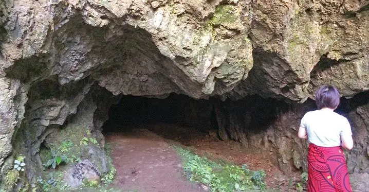 A Tourist at the entrance of the Snake God Cave in Wailotua Village.