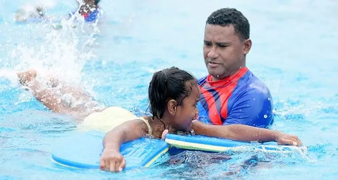 Dolphin swimming club instructor Peni Tuivanualevu assist 7 year-old Elina Vuniwai during swimming lesson at National Aquatic centre on September 22, 2020. Photo: Ronald Kumar.