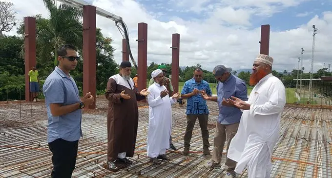 Imam Hafiz Musa Patel (second from left) praying and asking for blessings last year for the new mosque building under construction in Nadi beside Prince Charles Park, for which he helped with the architectural plan.