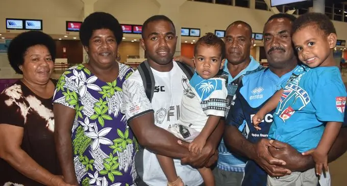 Fiji Airways 7’s rep Waisea Nacuqu with relatives at the Nadi International Airport on February 21, 2018. Photo: Waisea Nasokia