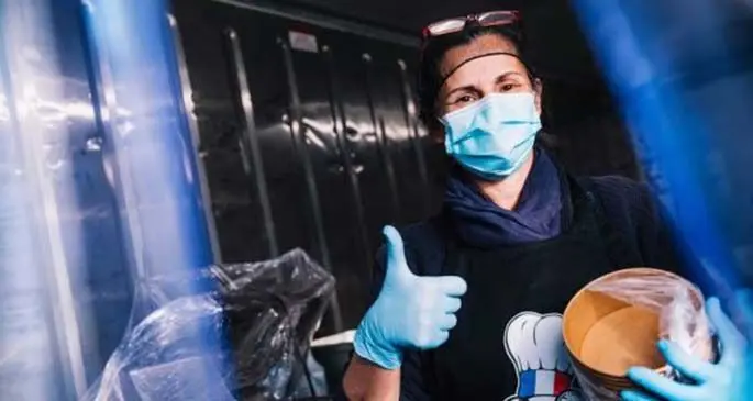 A volunteer prepares free food for medical workers at the kitchen of the Parc des Princes stadium in Paris, France, April 15, 2020. (PSG/Handout via Xinhua)