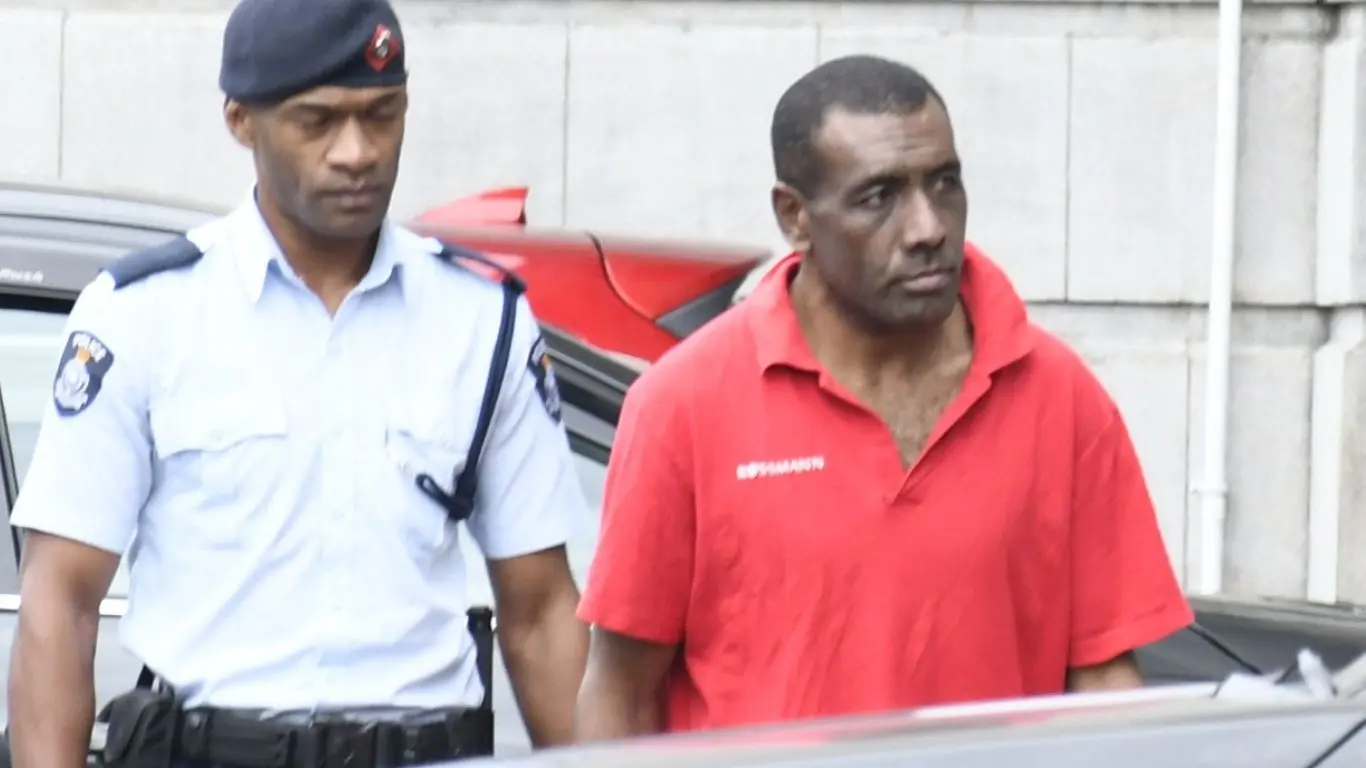 Murder accused Samuela Dasalusalu escorted by a police officer to the High Court in Suva on July 30, 2026.