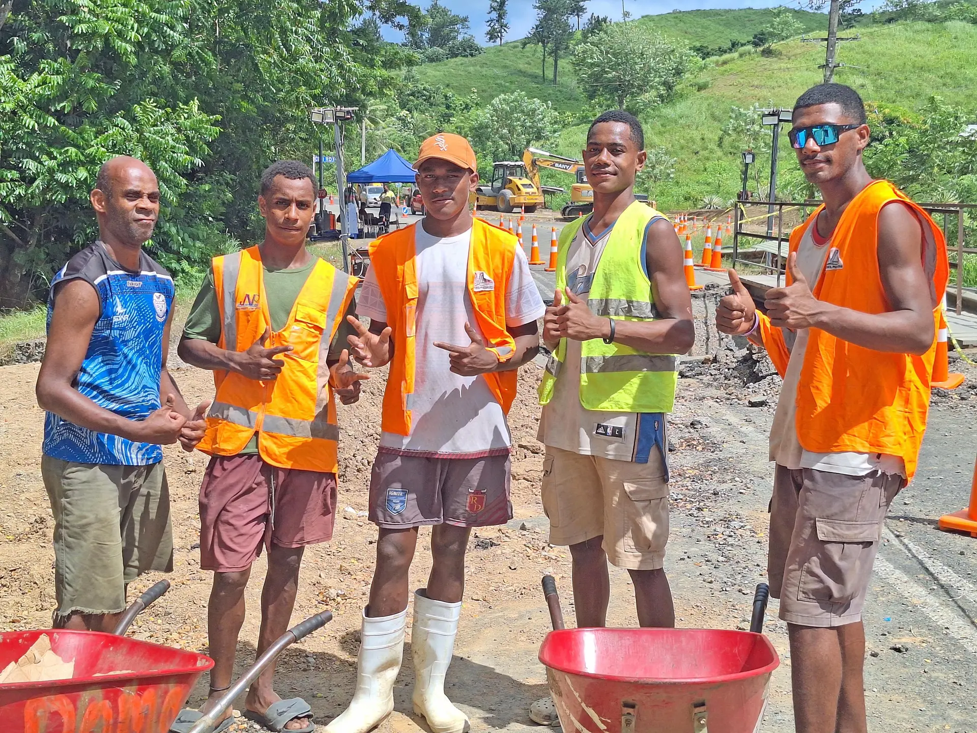 Ratu Naisa Navuma, Navuma Naruma, and Tony Lalevu, with their wheelbarrows at the Queens Highway at Semo Village in Nadroga