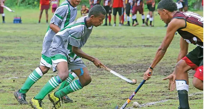 Levuka Public School hockey players Julian Varamua and Sefanaia Vakalelebula tussle for the ball against Tilak High School's Alipate Nakarawa during the Sportsworld Fiji Secondary Schools hockey tournament Under-19 match at the Nasau ground, Levuka on October 5, 2022. Photo: Manhar Vithal. 