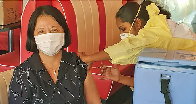 Tammie Tam, President of Warwick Hotels and Resorts International and Executive Director–Pacific, receiving her second vaccine jab from a medical personnel at Maui Bay.