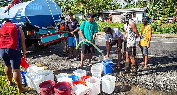 Residents along Khalsa Road fills empty buckets as water cuts remain a continued problem in the area on May 4, 2021. Photo: Leon Lord