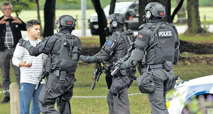 Officers from the Armed Offenders Squad push back members of the public following the shooting at Masjid al Noor mosque in central Christchurch, New Zealand, on March 15, 2019.