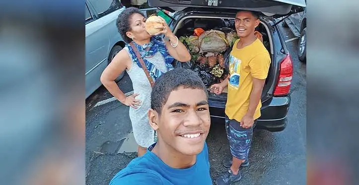 Ilisabeta Waqa (back left), with her children outside the Suva Market.